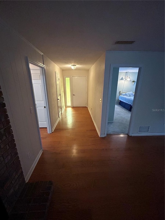 hallway with hardwood / wood-style flooring