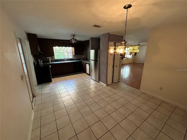 kitchen with ceiling fan with notable chandelier, decorative light fixtures, stainless steel refrigerator, and light tile patterned flooring