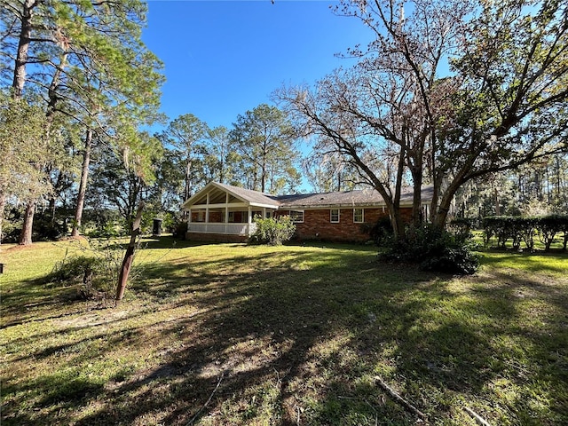 view of yard featuring a sunroom