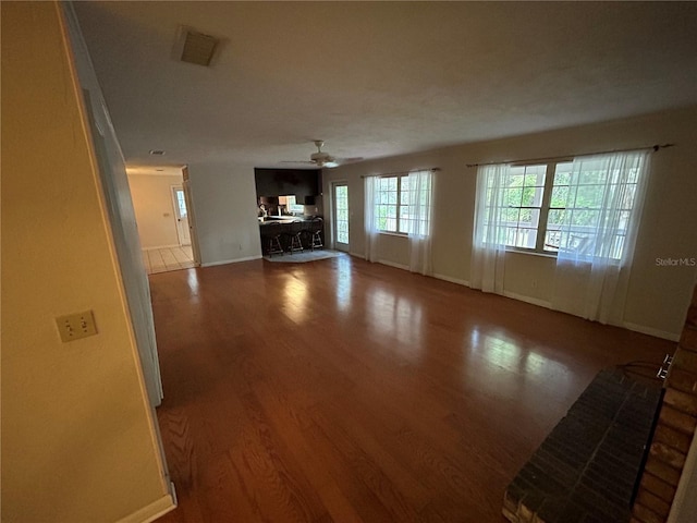 unfurnished living room with hardwood / wood-style floors and ceiling fan