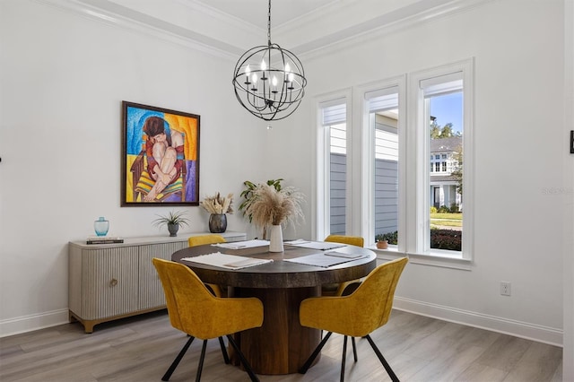 dining space featuring hardwood / wood-style flooring, a healthy amount of sunlight, and crown molding