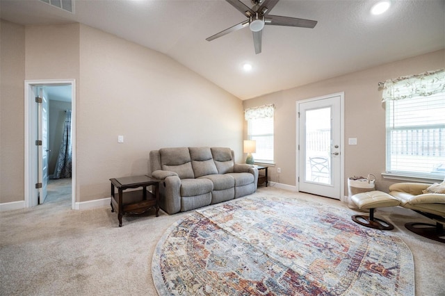 carpeted living room featuring ceiling fan, a healthy amount of sunlight, and lofted ceiling