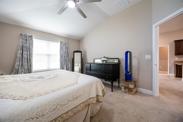 carpeted bedroom with ceiling fan and vaulted ceiling