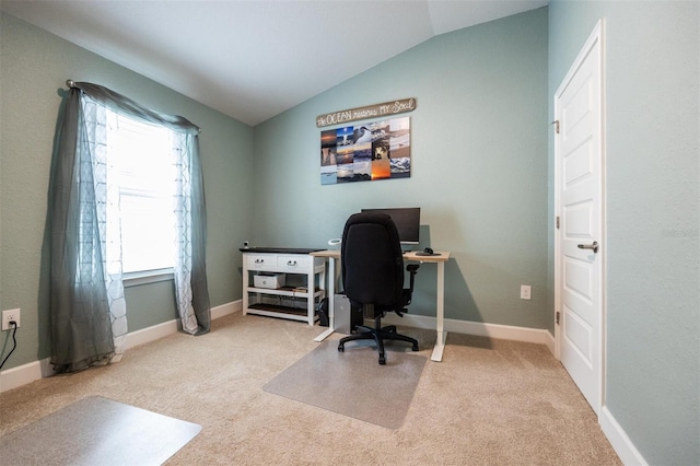 carpeted home office featuring lofted ceiling