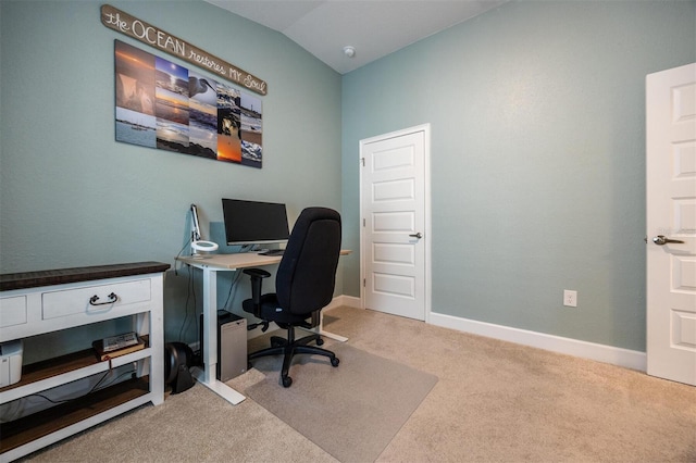 carpeted office featuring lofted ceiling