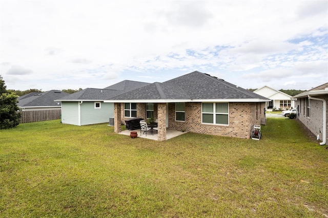 back of property featuring a yard and a patio