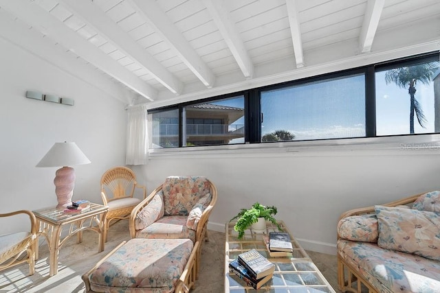 sitting room with vaulted ceiling with beams and a wealth of natural light