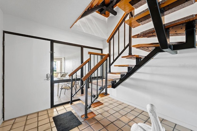 staircase featuring tile patterned floors