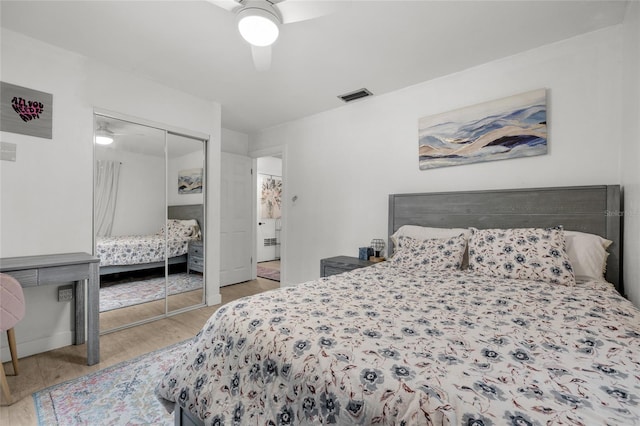 bedroom featuring a closet, ceiling fan, and light hardwood / wood-style flooring