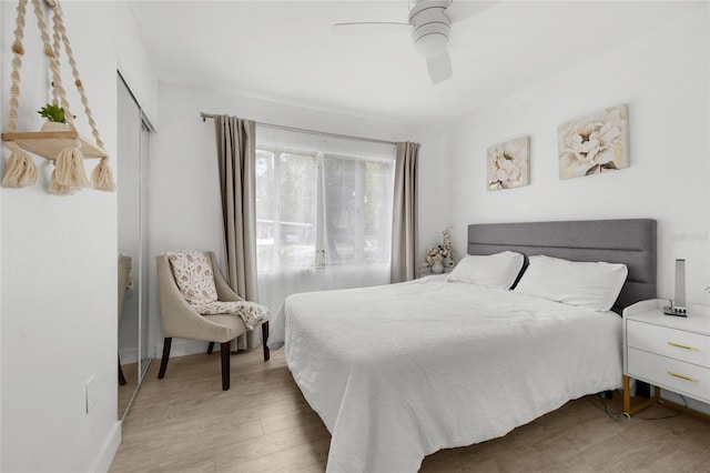 bedroom with a closet, ceiling fan, and hardwood / wood-style floors