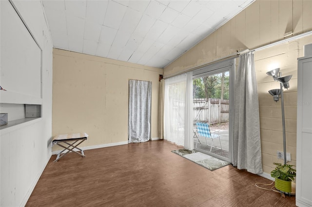 interior space with lofted ceiling and dark wood-type flooring