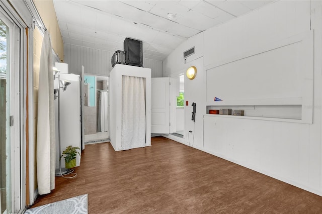 interior space with dark wood-type flooring and lofted ceiling