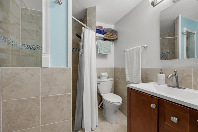 bathroom featuring tile patterned floors, vanity, tile walls, toilet, and curtained shower