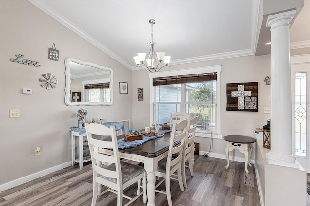 dining area featuring hardwood / wood-style floors, decorative columns, vaulted ceiling, and a notable chandelier