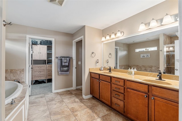 bathroom featuring plus walk in shower, tile patterned floors, and vanity