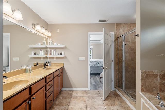 bathroom with tile patterned flooring, a shower with shower door, and vanity