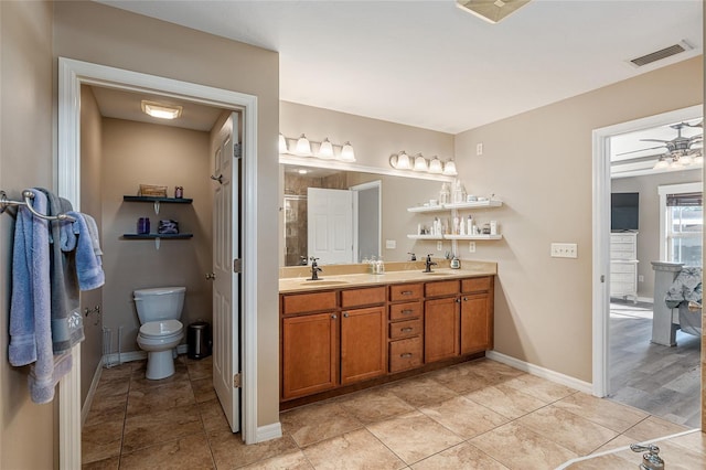 bathroom featuring toilet, tile patterned floors, ceiling fan, and vanity