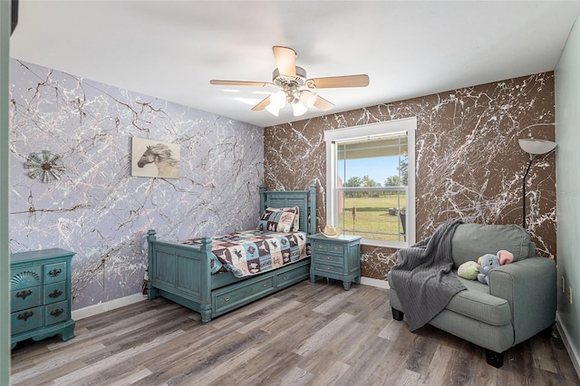 bedroom with ceiling fan and light hardwood / wood-style flooring