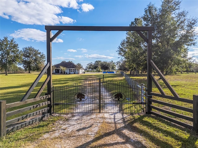 view of gate featuring a yard