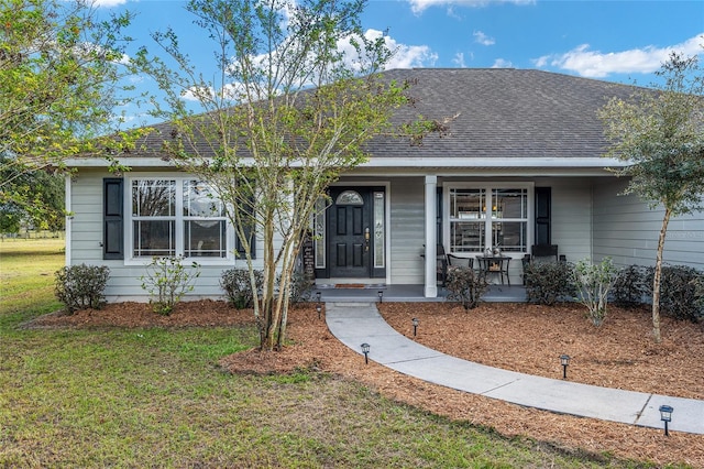 ranch-style home with covered porch and a front yard