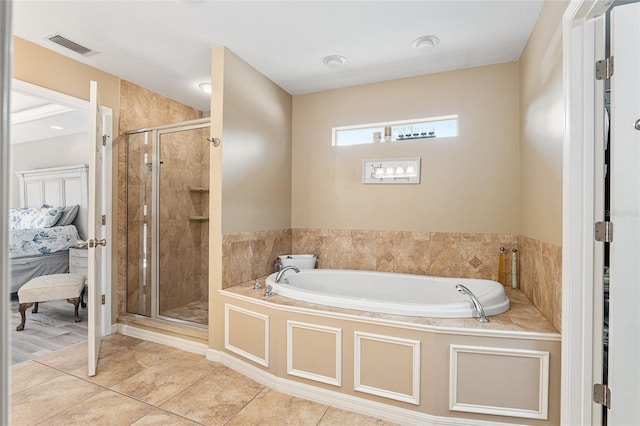 bathroom featuring tile patterned floors and separate shower and tub