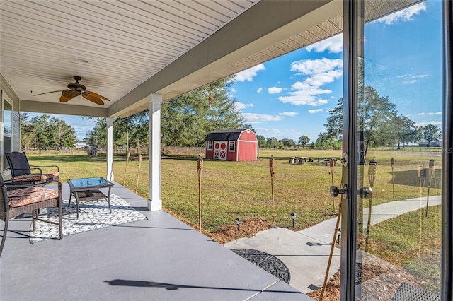 view of patio / terrace featuring ceiling fan and a storage unit