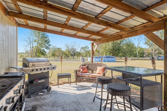 view of patio with a pool and grilling area