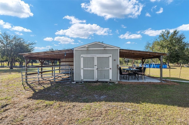 view of outbuilding featuring a yard