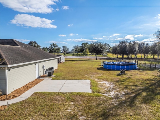 view of yard featuring a covered pool and a rural view