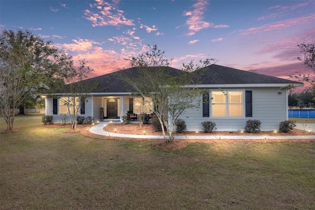 ranch-style house featuring a yard