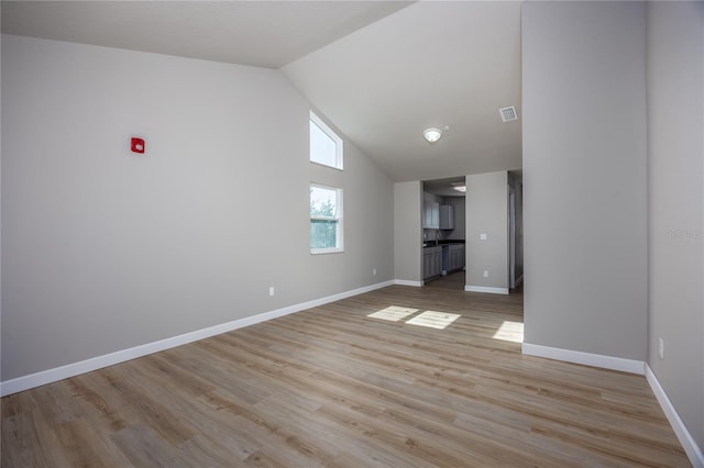 unfurnished living room featuring light hardwood / wood-style floors and vaulted ceiling