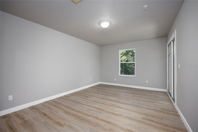 empty room featuring light hardwood / wood-style floors and a textured ceiling