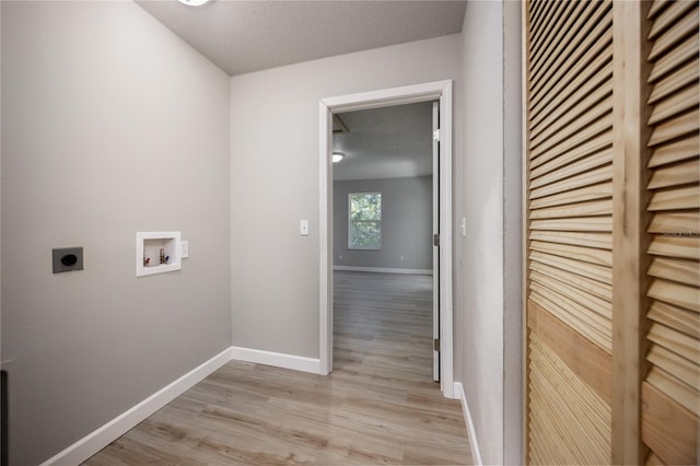 laundry room featuring hookup for a washing machine, light hardwood / wood-style flooring, a textured ceiling, and hookup for an electric dryer