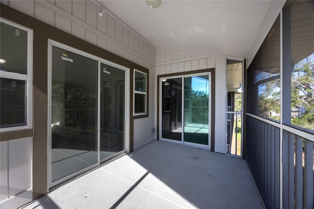 unfurnished sunroom with lofted ceiling