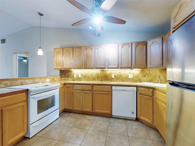 kitchen with sink, white appliances, decorative light fixtures, and backsplash