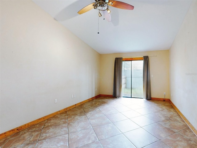 empty room featuring ceiling fan, light tile patterned flooring, and lofted ceiling