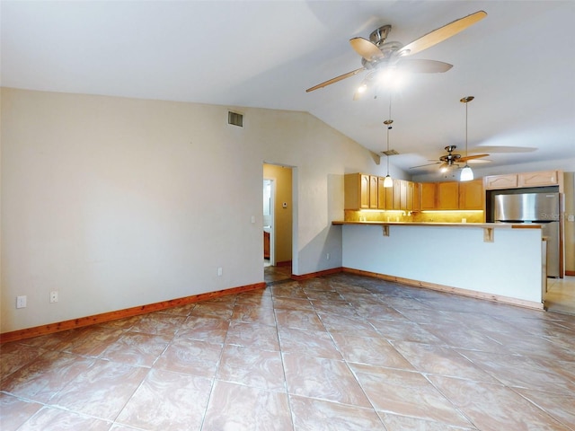 unfurnished living room with ceiling fan, lofted ceiling, and light tile patterned floors