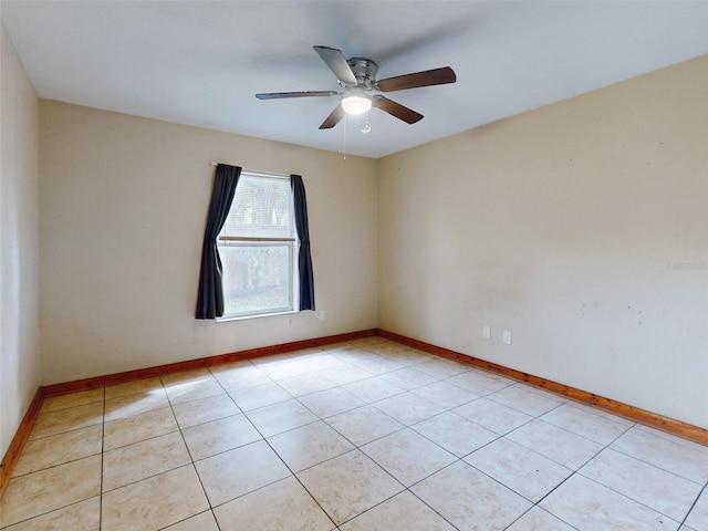 tiled spare room with ceiling fan