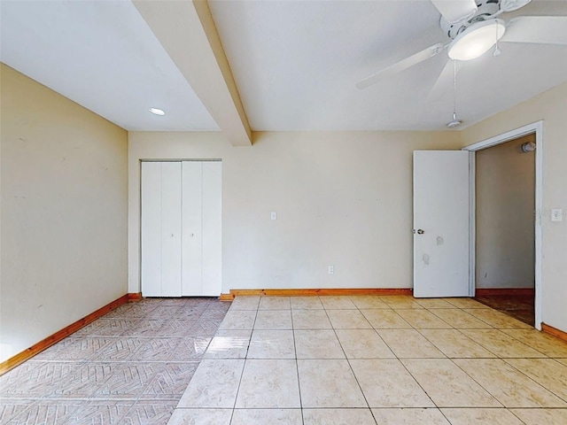 unfurnished bedroom featuring light tile patterned floors, a closet, ceiling fan, and beam ceiling