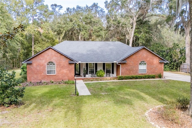 single story home featuring a porch and a front yard