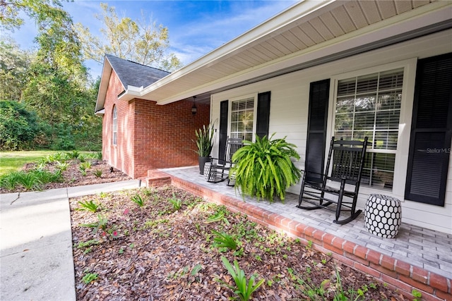 view of exterior entry with a porch