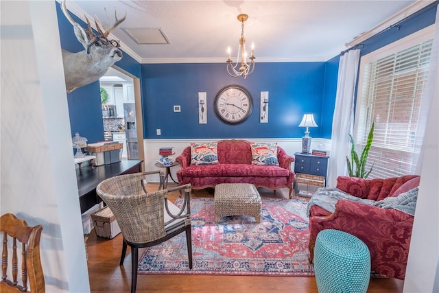 living room with hardwood / wood-style floors, a wealth of natural light, and ornamental molding