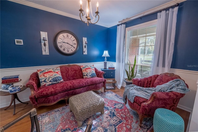 living room featuring crown molding, wood-type flooring, and an inviting chandelier