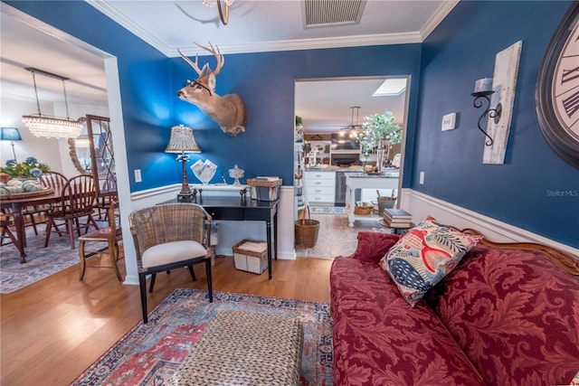 interior space with hardwood / wood-style flooring, crown molding, and a notable chandelier