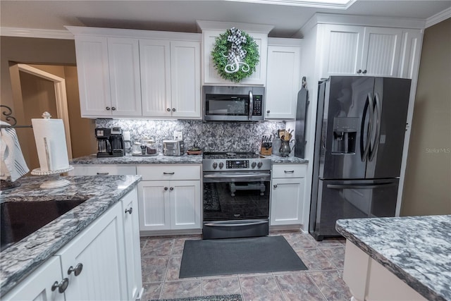 kitchen featuring white cabinets, light stone countertops, and appliances with stainless steel finishes