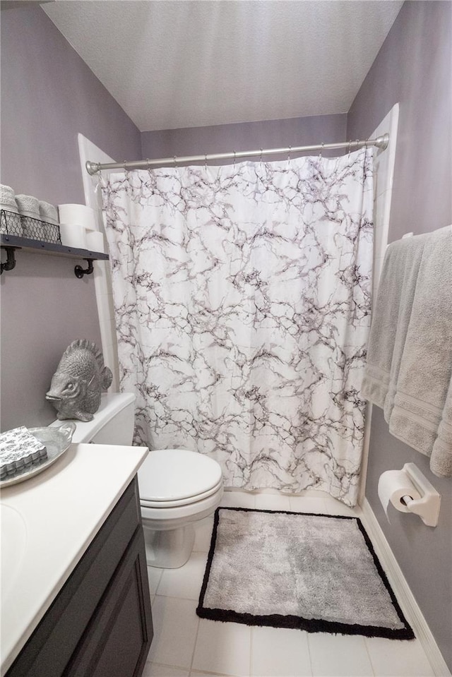 bathroom with a shower with curtain, a textured ceiling, vanity, tile patterned flooring, and toilet