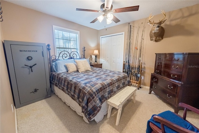 bedroom featuring ceiling fan, light colored carpet, and a closet