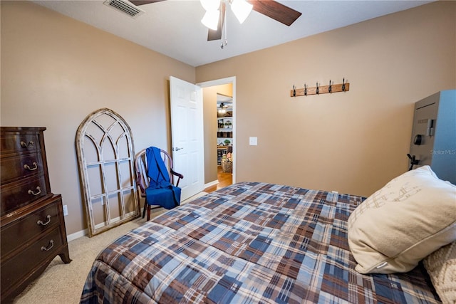 bedroom with ceiling fan and light carpet