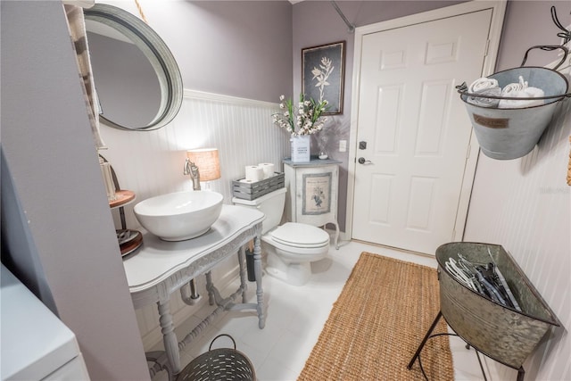 bathroom with tile patterned flooring, toilet, and sink