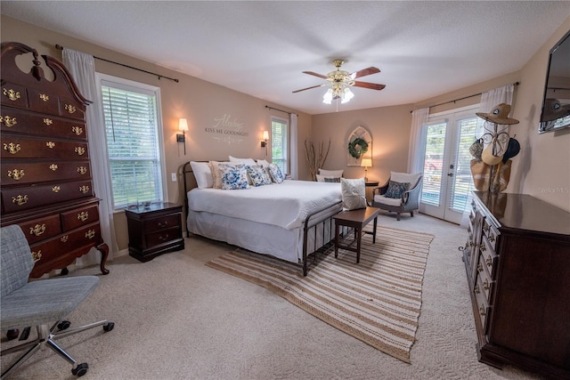 bedroom featuring french doors, ceiling fan, access to exterior, a textured ceiling, and light colored carpet